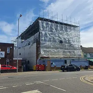 scaffolding and sheets over building
